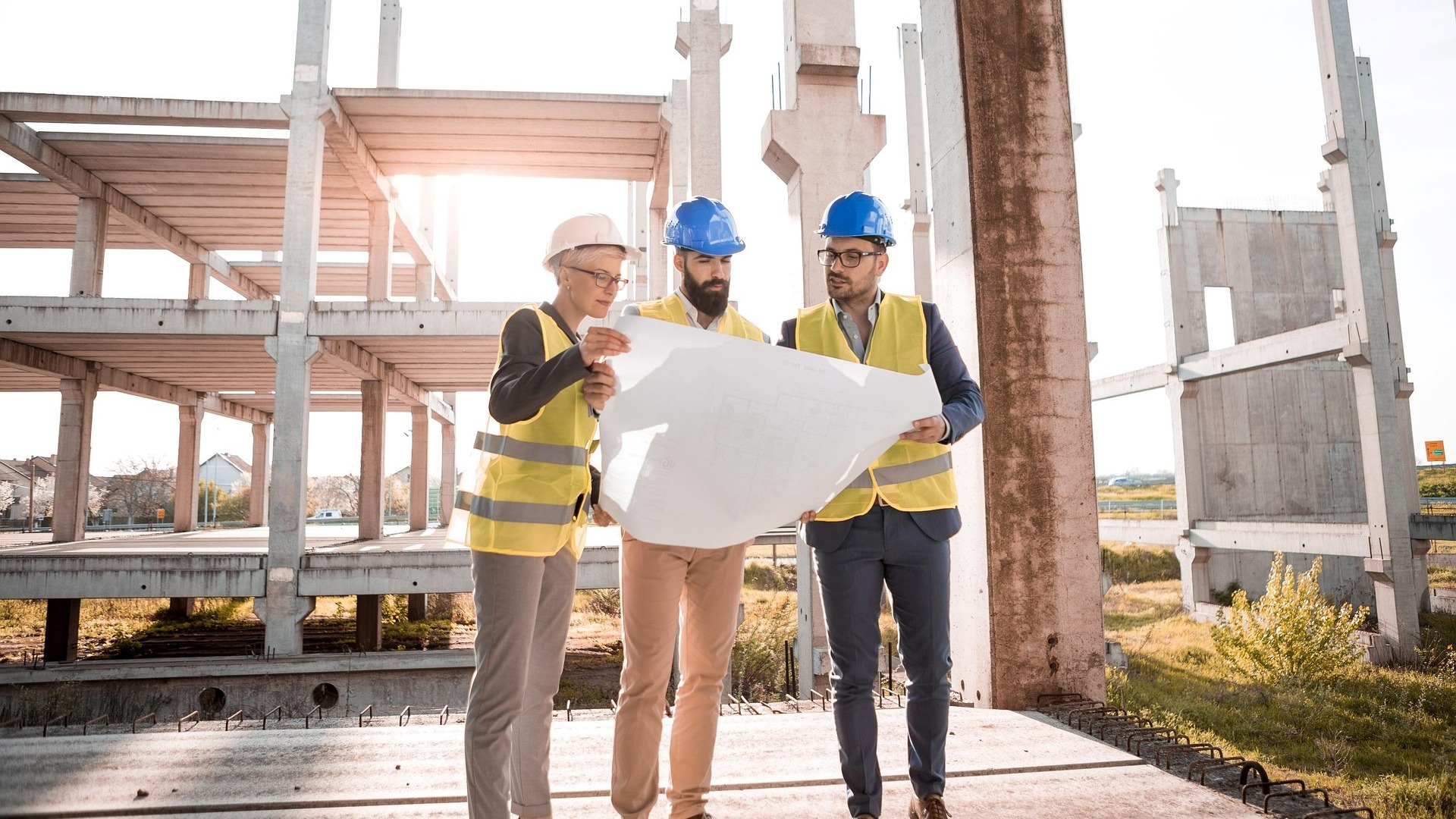 Construction professionals reviewing plans on a jobsite