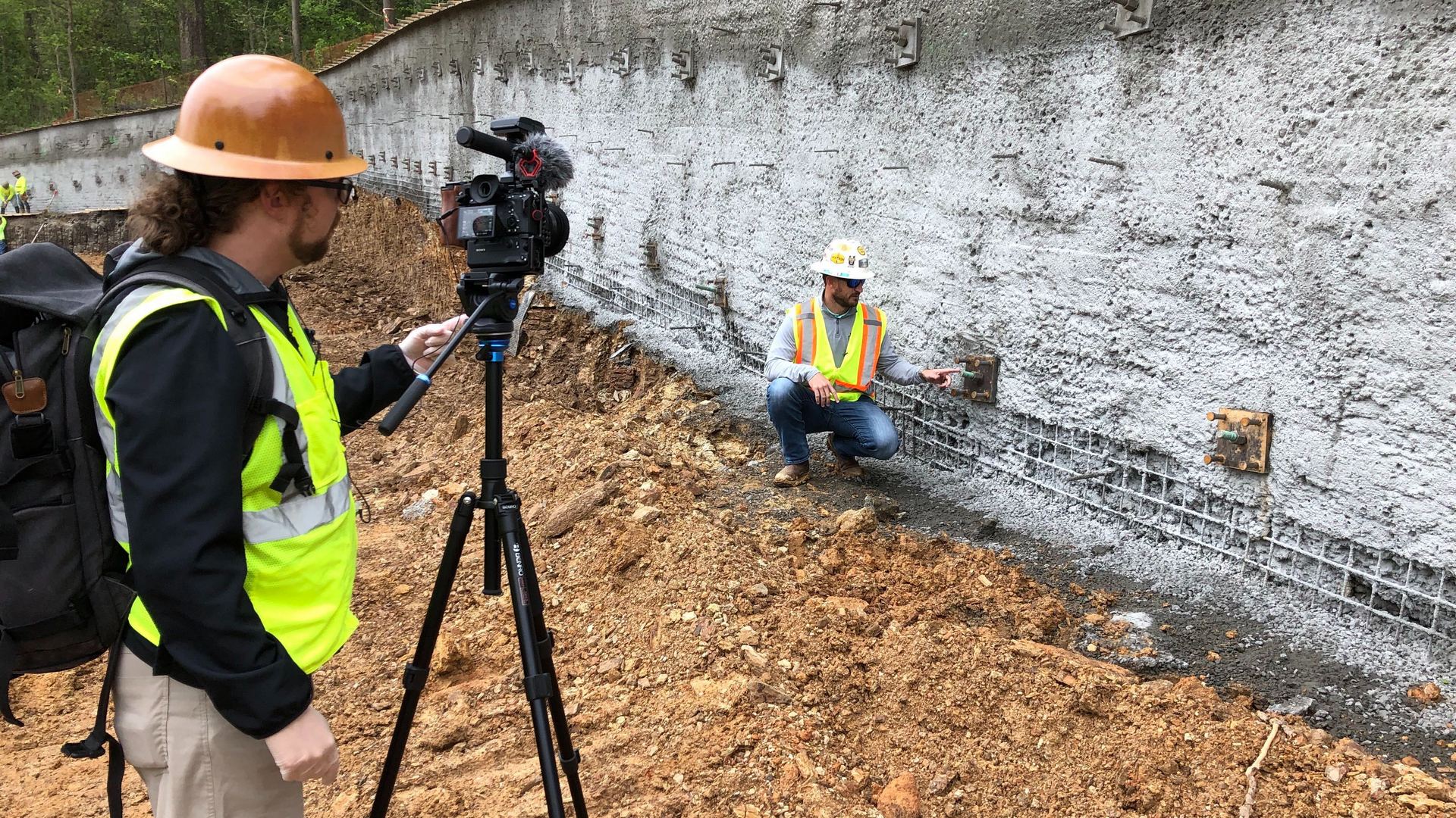 Videographer filming a construction worker on a jobsite