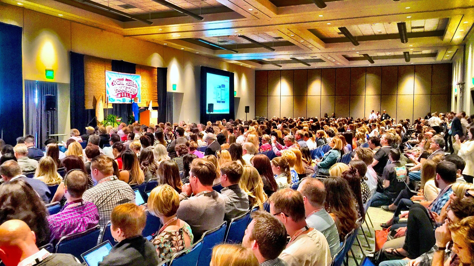 Audience listening to a speaker at a conference
