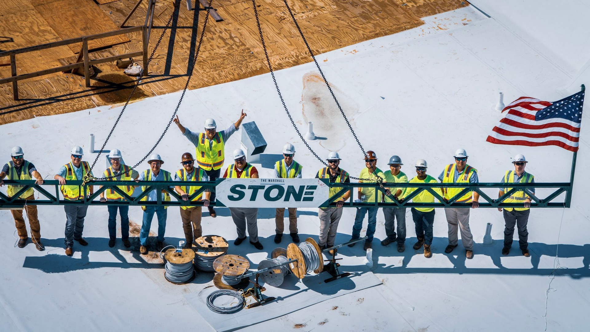 Construction crew standing together on a rooftop