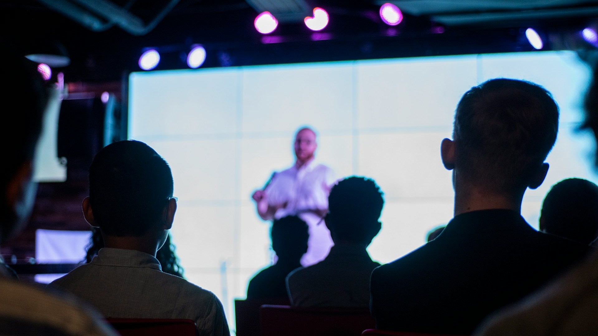 Business representative speaking into a microphone on a stage